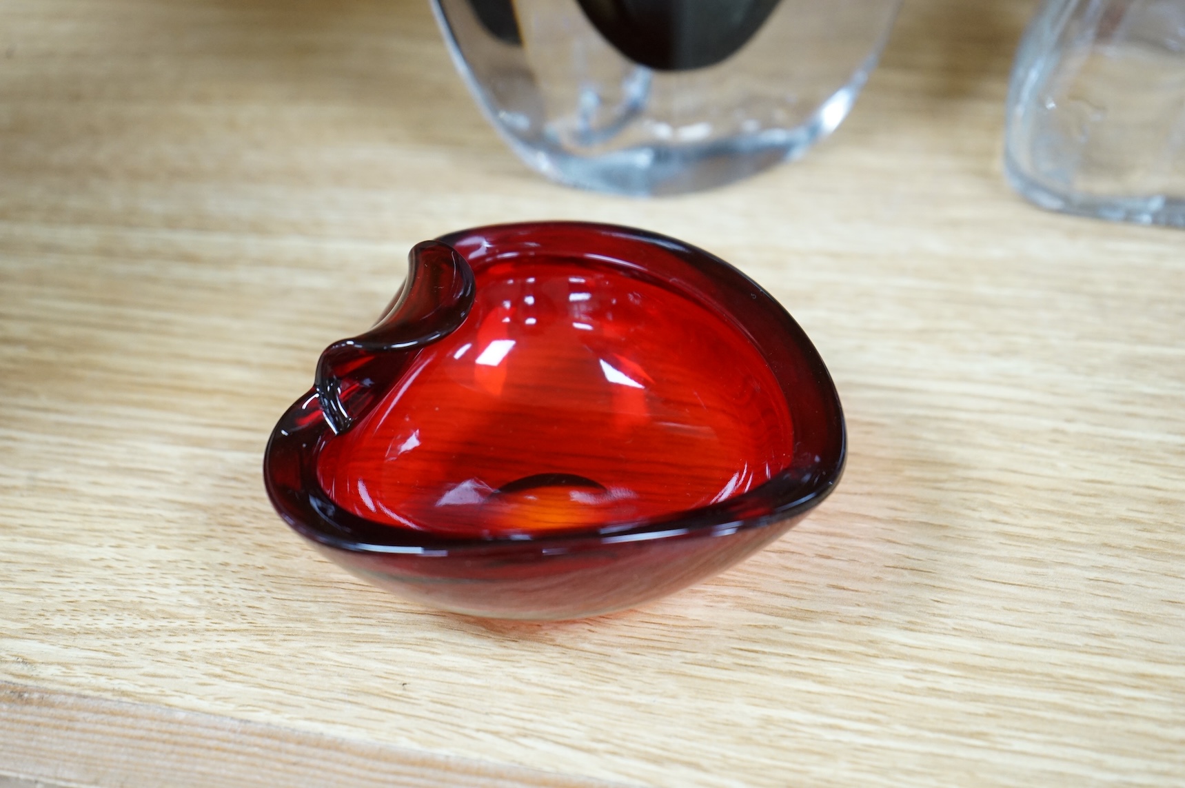 A collection of glassware including a Kosta Boda snowball pot and an Evian advertising water bottle, largest 23cm high